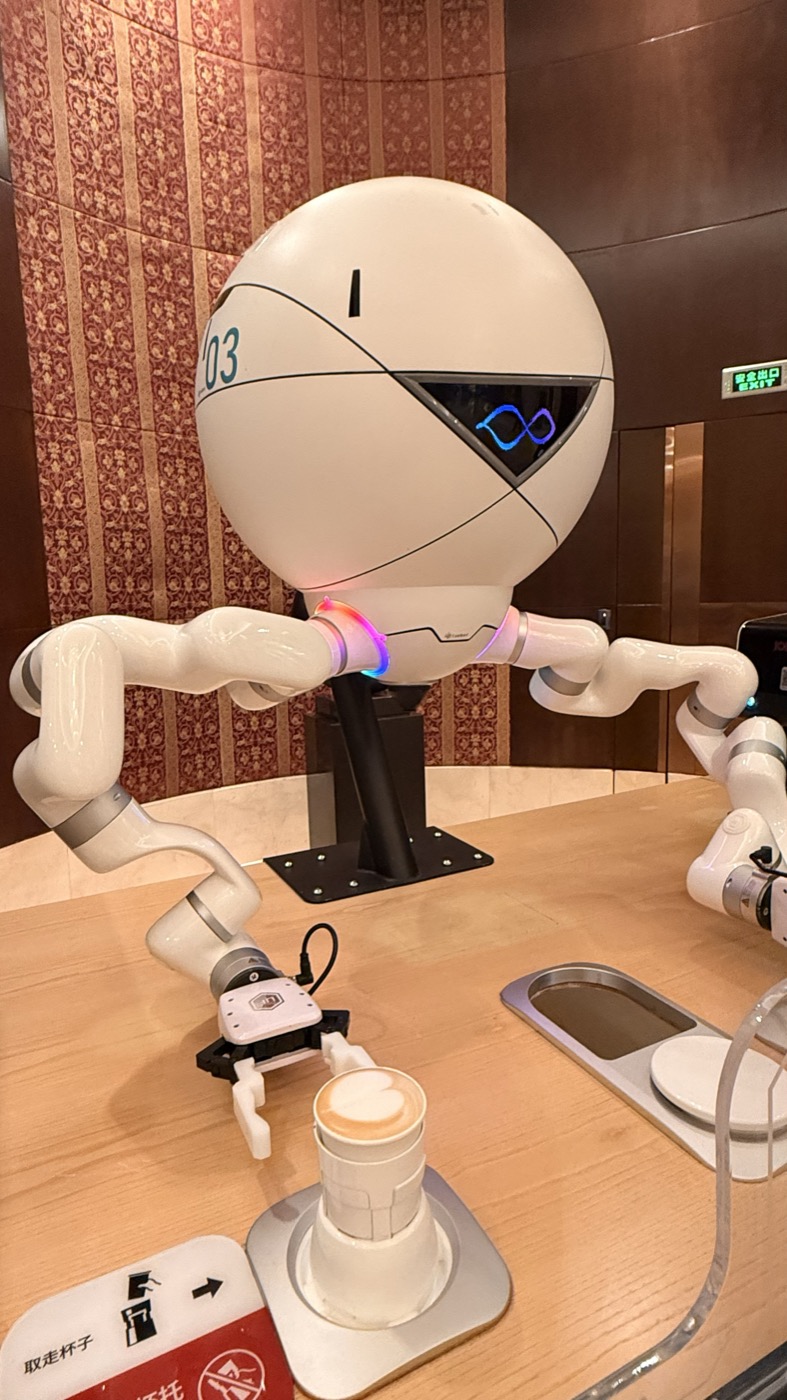 A service robot preparing coffee at a warm wooden counter
